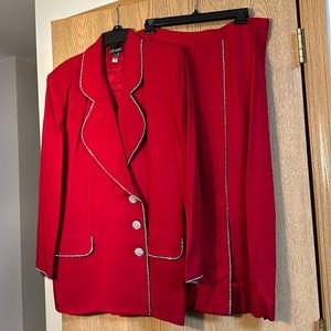 Red two piece skirt suit made of rayon and acetate size 14 skirt has side slit.